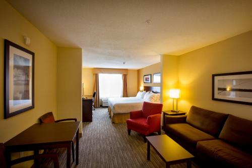 a hotel room with a bed and a couch at Holiday Inn Express Stellarton-New Glasgow by IHG in Stellarton