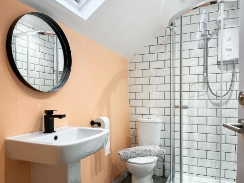 a bathroom with a sink and a toilet and a mirror at The Old Hayloft-uk39431 in Dronfield