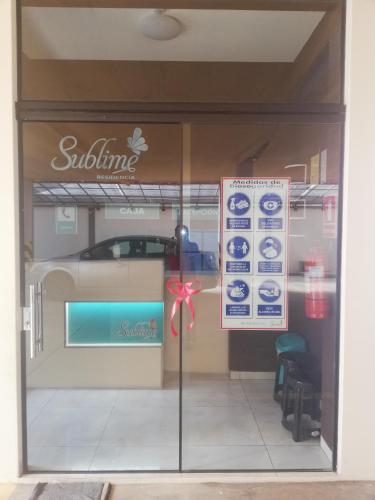 a window of a store with a red bow on it at Hostal sublime in Cochabamba