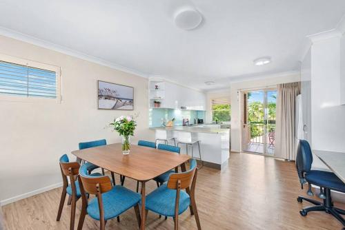 a kitchen and dining room with a table and chairs at Bright & Breezy ~ 2 Bed/2 Bath /1 Car/ Views! in Brisbane