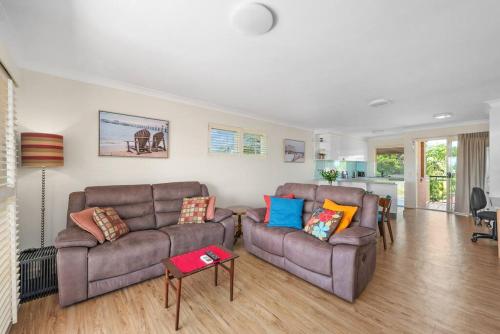 a living room with two couches and a table at Bright & Breezy ~ 2 Bed/2 Bath /1 Car/ Views! in Brisbane
