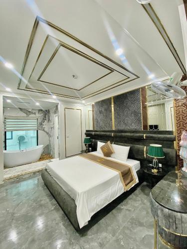a bedroom with a large bed and a bath tub at Bao Ngoc hotel Pháp Vân in Hanoi