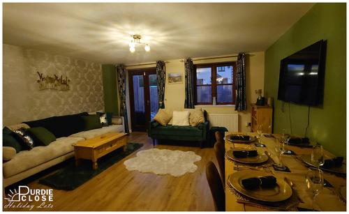 a living room with a couch and a table at Purdie Close Holiday Let in Cheddar