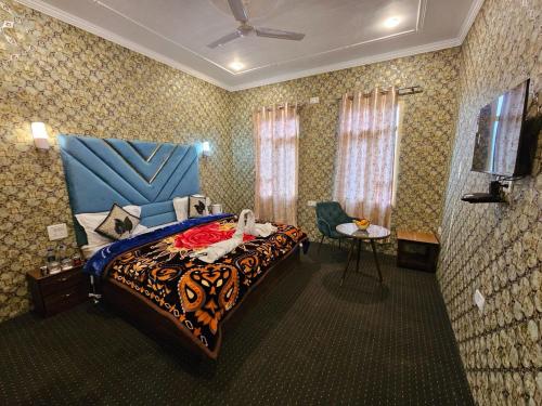 a bedroom with a bed and a chair in it at Hotel Nouvella Residency in Srinagar