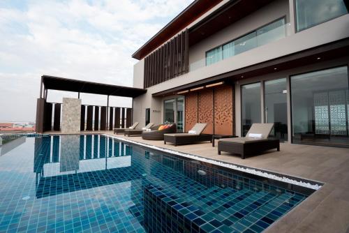 a house with a swimming pool on a building at Mintra Hotel in Vientiane