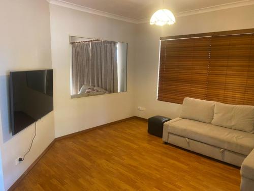 a living room with a couch and a flat screen tv at Hook Wine & Sinker in Dunsborough