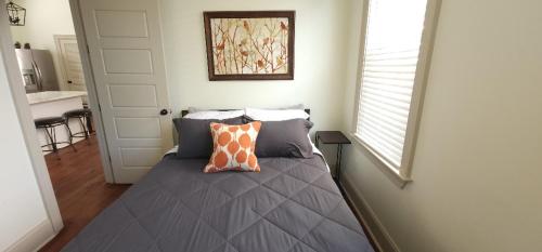 a bedroom with a bed with two pillows on it at La Belle Cottage II 2queenbeds 10min to French Qtr in New Orleans