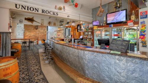 a bar in a restaurant with a counter top at Union Hotel Tumbarumba in Tumbarumba