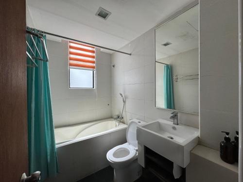 a bathroom with a white toilet and a sink at Studio at Samsuria Beach Resort in Kampung Sungai Ular