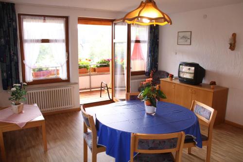 a living room with a table with a blue table cloth at Landgasthof Adler Pelzmühle in Biederbach Baden-Württemberg