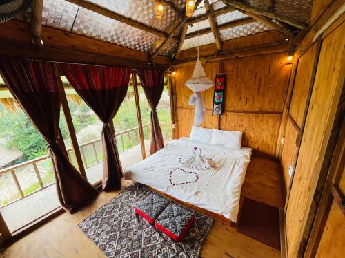 a bedroom with a bed in a wooden room at Cuisine Garden in Pu Luong