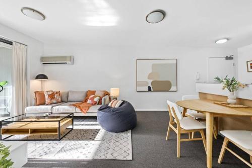 a living room with a couch and a table at Home away from Home! 2Bed/1Bath/Car/Pool~2kms CBD in Brisbane