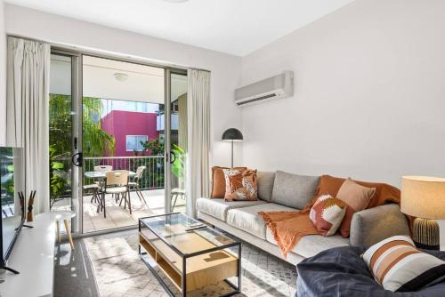 a living room with a couch and a glass table at Home away from Home! 2Bed/1Bath/Car/Pool~2kms CBD in Brisbane