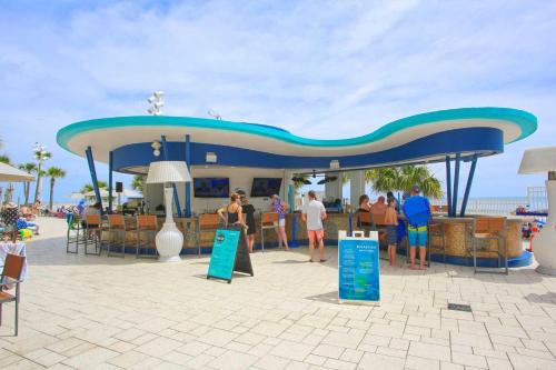 a group of people standing in front of a restaurant at Luxury 12th Floor 2 BR Condo Direct Oceanfront Wyndham Ocean Walk Resort Daytona Beach | 1201 in Daytona Beach