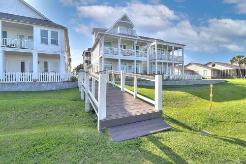 a white house with a wooden walkway in front of it at Casa de Flip Flops in Rockport