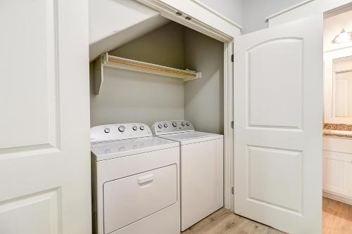 a white laundry room with a washer and dryer at Casa de Flip Flops in Rockport