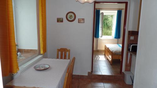 a room with a table and a room with a window at Guest House Melusine in Loučná pod Klínovcem