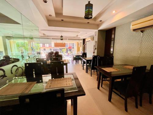 a dining room with tables and chairs in a restaurant at The Rio Lodge, Haridwar in Haridwār