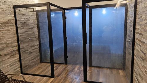 a room with glass doors on a brick wall at Resort QSB - Um novo padrão de conforto e lazer no coração da cidade in Pirenópolis