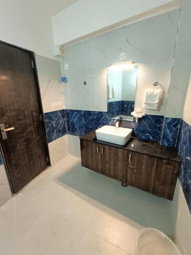 a bathroom with a sink and a mirror at The HighGarden Resort in Udaipur
