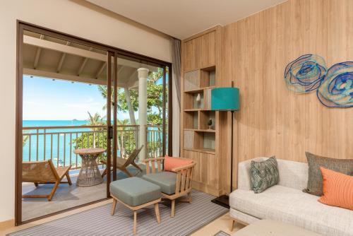 a living room with a couch and a balcony at Holiday Inn Resort Samui Bophut Beach by IHG in Bophut 