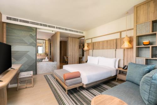 a hotel room with a bed and a couch at Holiday Inn Resort Samui Bophut Beach by IHG in Bophut 
