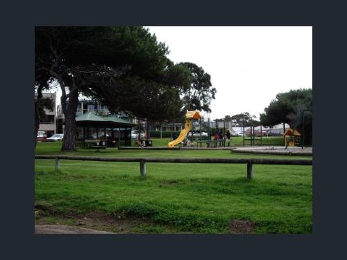 a park with a playground with a yellow slide at Sally's Kingscote Retreat-2 units with 4 bedrooms in Kingscote, Kangaroo Island in Kingscote