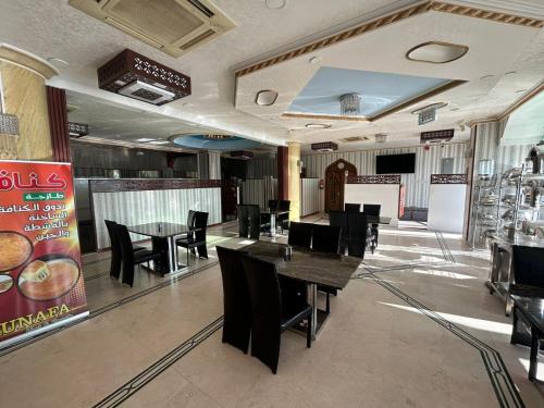 une salle à manger avec des tables et des chaises dans un restaurant dans l'établissement Safari Hotel, à Nizwa