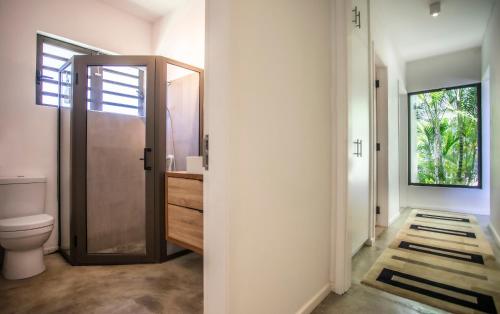 W łazience znajduje się toaleta, umywalka i lustro. w obiekcie Beach Villa Poema w mieście Centre de Flacq