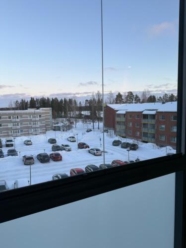 a view of a parking lot with cars in the snow at apartment in Lappeenranta