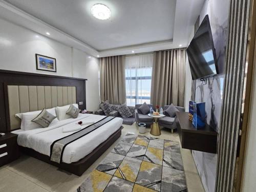 1 dormitorio con 1 cama grande y sala de estar en فندق ماريوت عدن السياحي Marriott Aden Hotel, en Khawr Maksar
