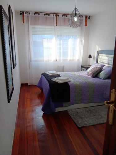 a bedroom with a bed and a window at Casa Álvaro in Marín