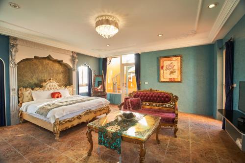 a bedroom with a king sized bed and a couch at Sharjah B&B in Wujie