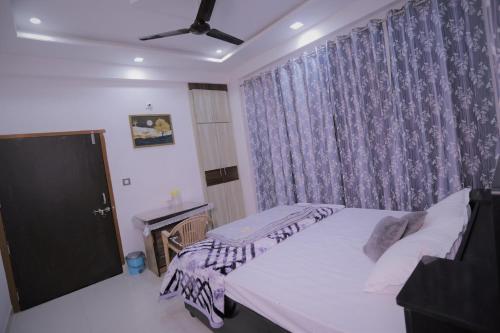 a bedroom with two beds and a window at Bhagora CJMA Home Stay/Villa in Udaipur