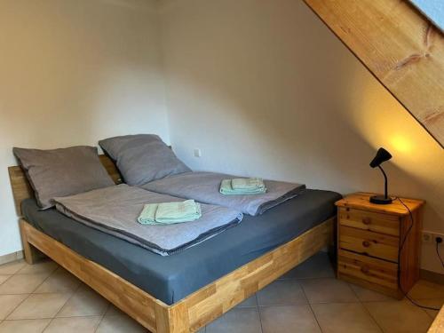 a bedroom with a bed with a nightstand and a staircase at Titisee Traumblick in Hinterzarten