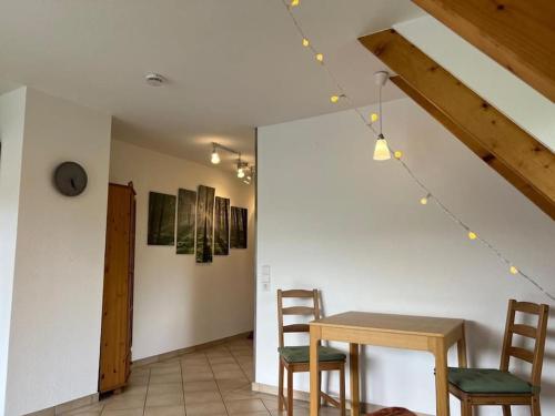 a dining room with a table and two chairs at Titisee Traumblick in Hinterzarten