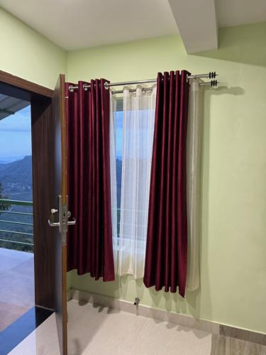 a bathroom with red curtains and a window at Belle Bonami Resort in Vagamon