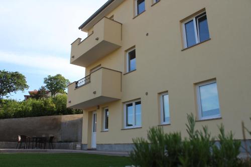 a building with stairs on the side of it at Apartmani Marin1 in Vrbnik