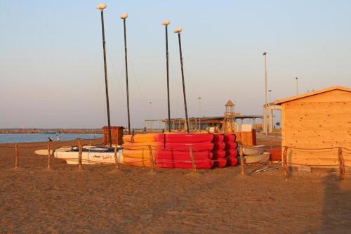 a group of boats on a beach with a building at Luxury Apartment Nador Jadid Only Family in Nador