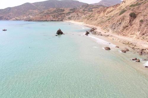 a beach with blue water and a mountain at Luxury Apartment Nador Jadid Only Family in Nador