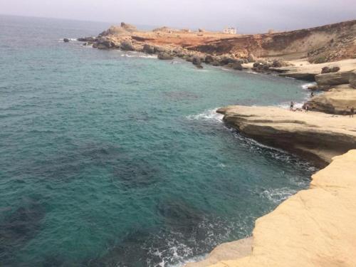 an aerial view of the ocean near a rocky shore at Luxury Apartment Nador Jadid Only Family in Nador