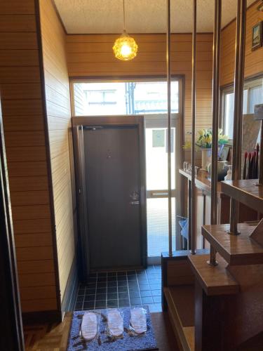 un pasillo con una puerta negra en una habitación en Classy仏生山, en Takamatsu