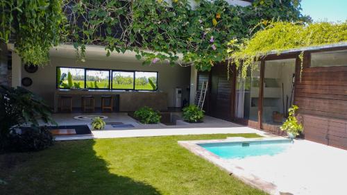 a garden with a swimming pool in a yard at Ocean Villa - Joshua District in Tabanan