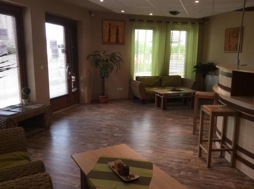 a living room with a couch and a table at Abszolút Hotel és Panzió in Nyírbátor