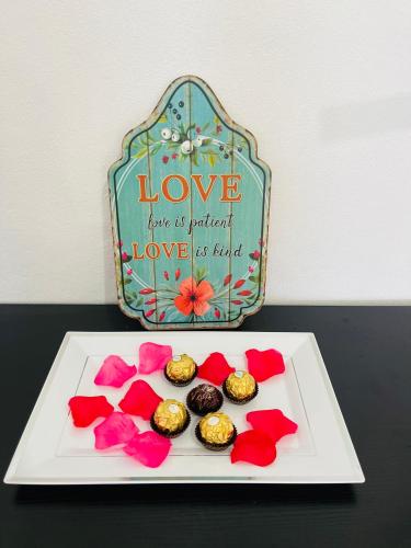 a plate with cupcakes and flowers on a table at Salt St Lucia Villa in Vieux Fort