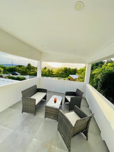 a balcony with a table and chairs and a view at Salt St Lucia Villa in Vieux Fort