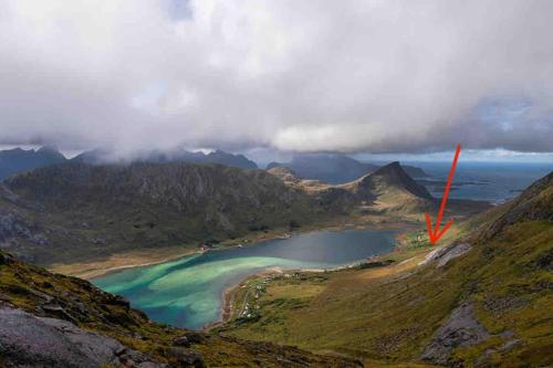 a view of a lake on the side of a mountain at Lofoten Fjord Apartment - Kvalvika Beach & Ryten in Skjelfjord