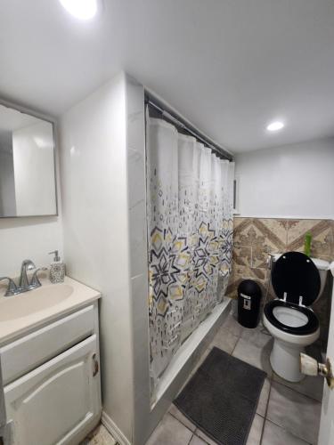 a bathroom with a toilet and a sink and a shower at Prime Location 3-Bed Close to NYC in Jersey City