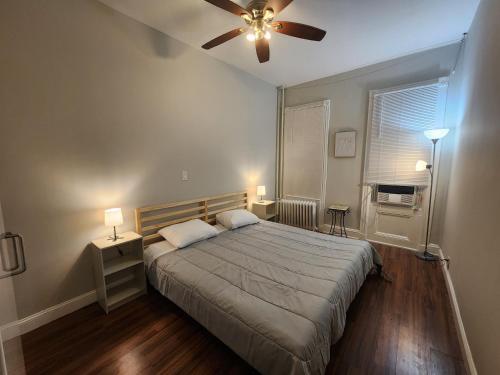 a bedroom with a bed and a ceiling fan at Prime Location 3-Bed Close to NYC in Jersey City