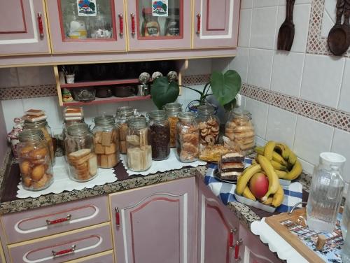 a kitchen counter with jars of food and fruit at La Casa de La Abuela Rosy in Málaga